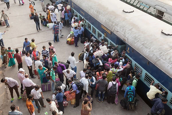 India, Bihar, Gaya, Passengers attempt to board an overcrowded second-class carriage of a train at Railway Station