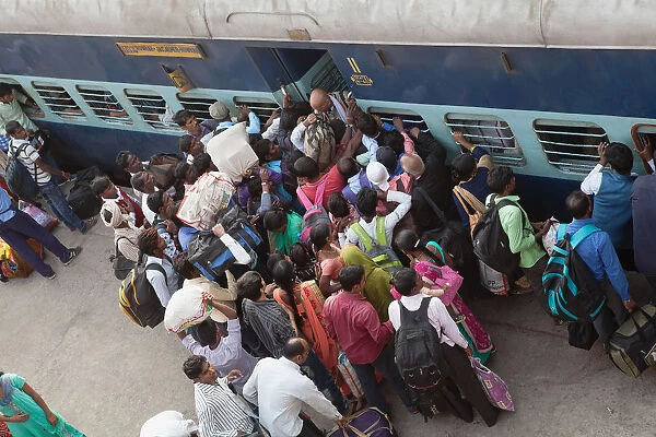 India, Bihar, Gaya, Passengers attempt to board an overcrowded second class carriage of a train at Railway Station