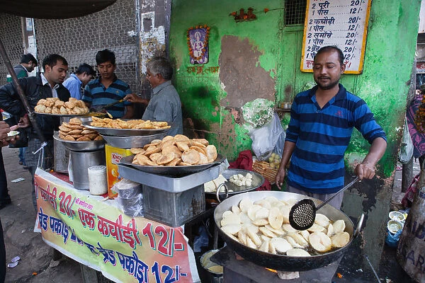 India, New Delhi, A cook making kachori at a street stall in the old city of Delhi