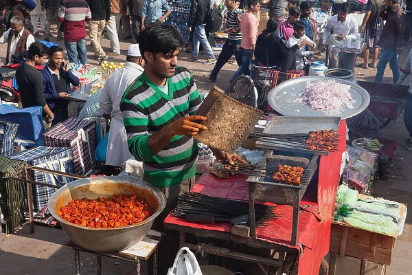 India, New Delhi, A food vendor grilling kebabs in the cotton market in the old city of Delhi