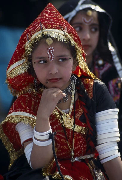 INDIA, Rajasthan, Alwar Young girl dancer wearing traditional jewellery at the Alwar