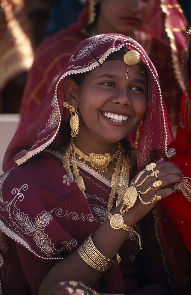 INDIA, Rajasthan, Bikaner Portrait of a young girl dancer smiling wearing traditional