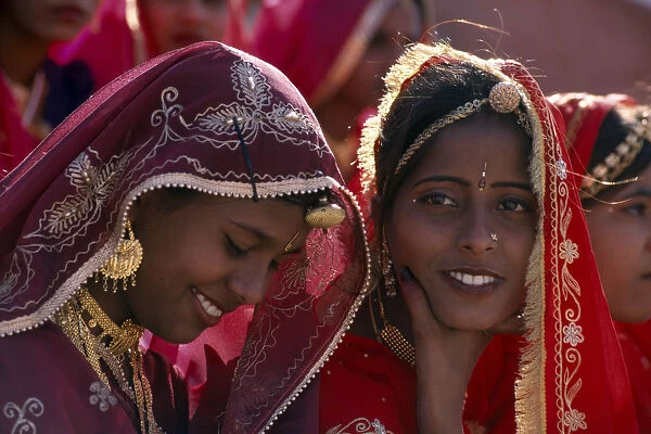 INDIA, Rajasthan, Bikaner Young girl dancers smiling at the Camel Festival