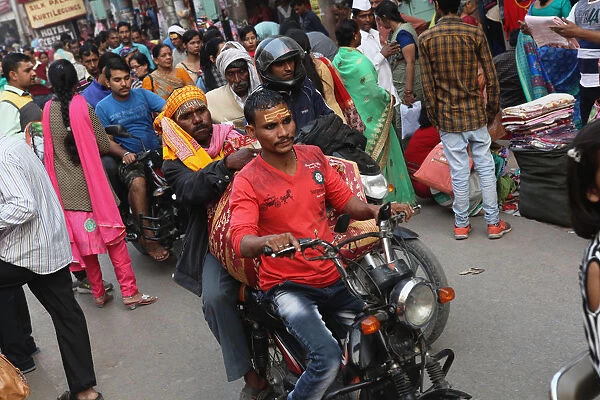 India, Uttar Pradesh, Varanasi, Motorcyclist on Dashashwamedh Ghat Road