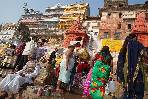 India, Uttar Pradesh, Varanasi, Pilgrims on the ghats beside the Ganges at Varanasi