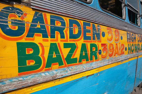 India, West Bengal, Kolkata, Public bus with its destination to Garden Bazaar painted in bright colours on its side panel