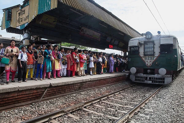 India, West Bengal, Kolkata, A train arrives at the platform at Garia Railway Station