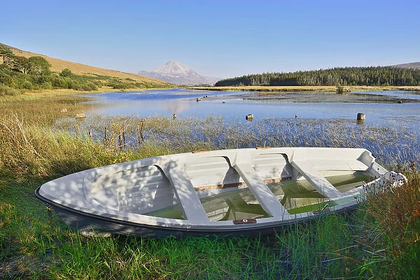 Ireland, County Donegal, Clady River with Mount Errigal in the distance and a rowing boat in the foreground