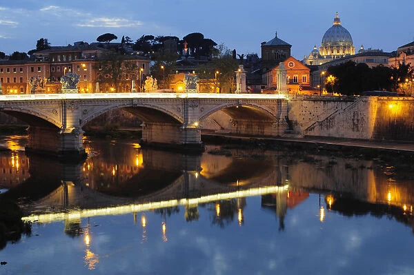 Italy, Lazio, Rome, Castel Sant Angelo, night view from Ponte Sant Angelo to St Peters Basilica