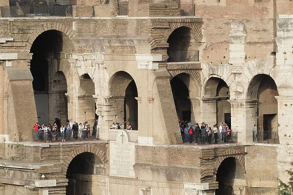 Italy, Lazio, Rome, Colosseum, view of Colosseum interior showing arches & different levels with people at viewpoints