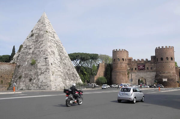 Italy, Lazio, Rome, Testaccio, Piramide de Caius Cestius with Porta de San Paolo & traffic passing