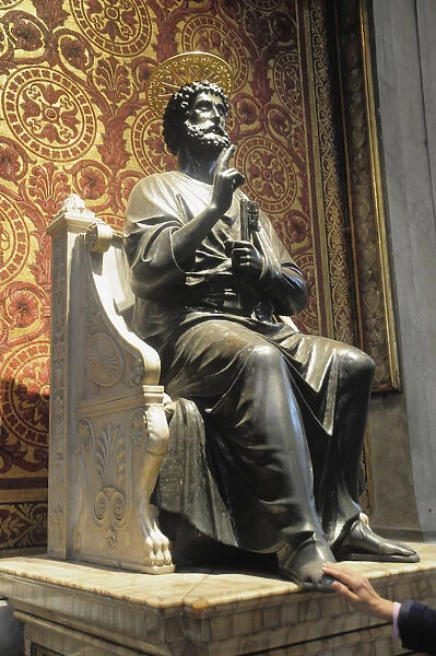 Italy, Lazio, Rome, Vatican City, St Peters Square, St Peters Basilica, bronze statue of St Peter with hand rubbing foot