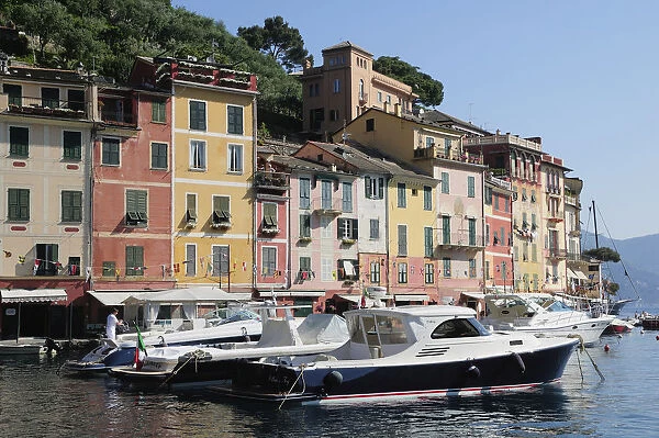 Italy, Liguria, Portofino, waterside houses with boats in the bay