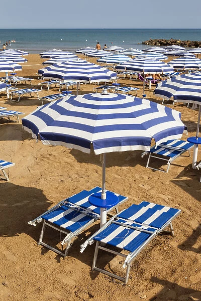Italy, Sicily, Marina Di Ragusa, Sun umbrellas and sun beds on a beach