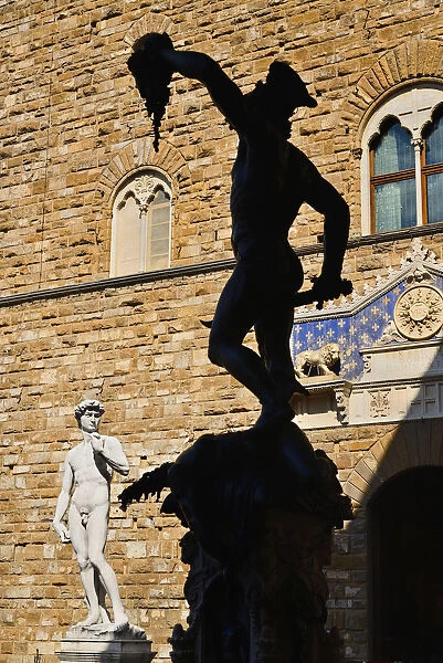 Italy, Tuscany, Florence, Piazza della Signoria, Replica of the famous David statue by Michelangelo with silhouette of the Perseus statue