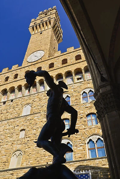 Italy, Tuscany, Florence, Piazza della Signoria, Palazzo Vecchio with the Perseus statue silhouetted