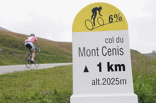 Italy, Valle d Aosta, cycle gradient sign with cyclist passing, Col du Mont Cenis