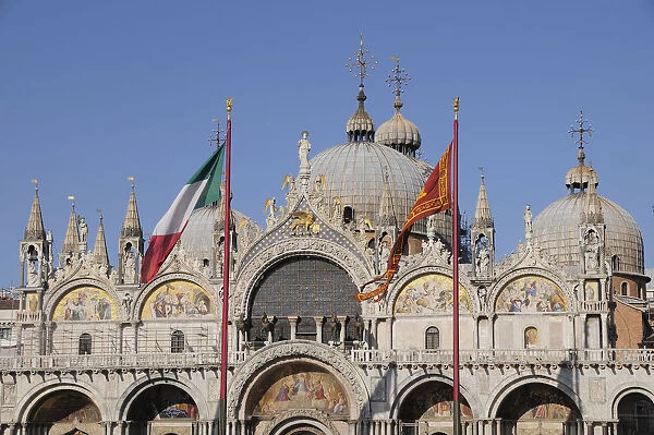 Italy, Veneto, Venice, domes of the Basilica of San Marco with flags