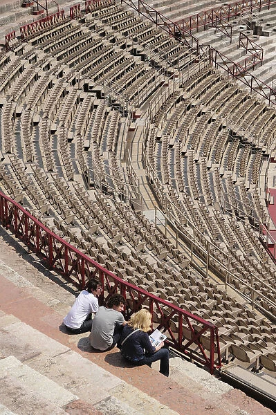 Italy, Veneto, Verona, Interior of Arena with group seated