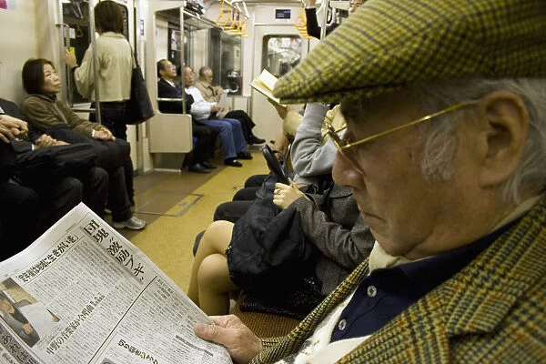 JAPAN 42. Japan /  Tokyo /  Tokyo Metro. Japanese man reading his newspaper