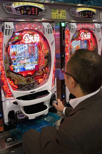 JAPAN 8. Japan /  Tokyo /  Shinjuku. Japanese man is gambling at electronic machine