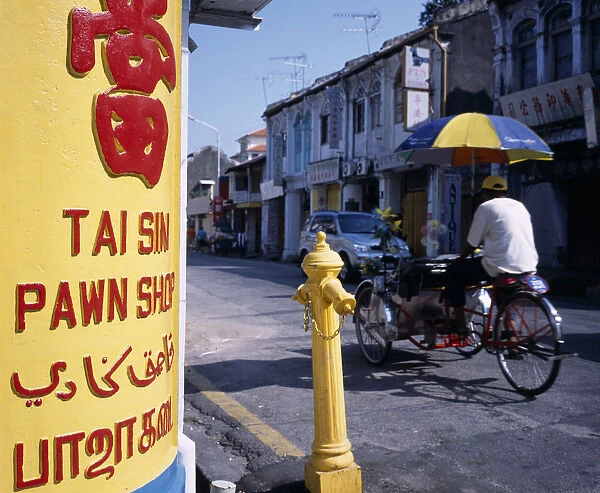 MALAYSIA, Penang, Georgetown Lebuh Chulia. Cycle rickshaw on street with yellow