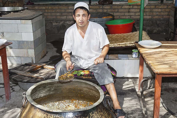 Man cooking plov, typical traditional Uzbek food, Navoi Province, Uzbekistan