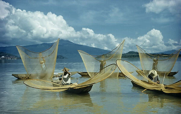 MEXICO, Michoacan, Patzcuaro Fishermen butterfly net fishing from canoes on Lake