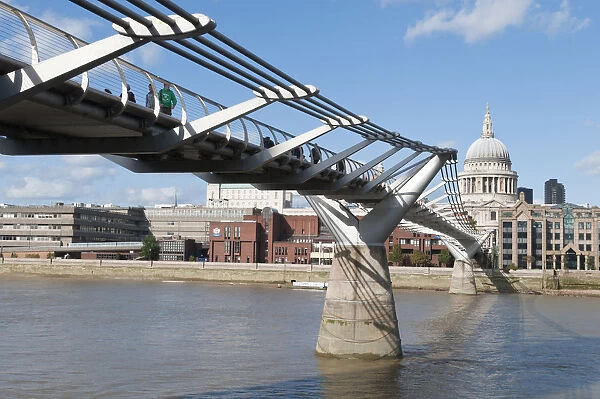 The Millennium bridge spans the river Thames between the Tate Modern art gallery