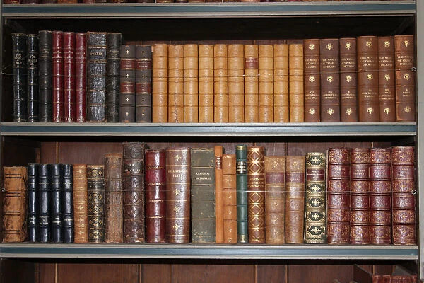 Old books on a book case inside Warwick Castle