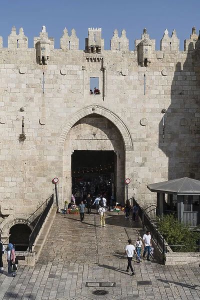 People pass through the Damascus gate in the walls of the Old City of Jerusalem