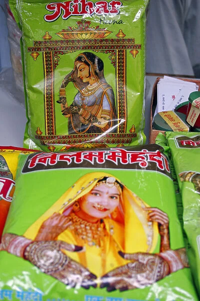 Plastic packets of henna for sale illustrated with pictures of attractive women with henna patterns on hands and wrists