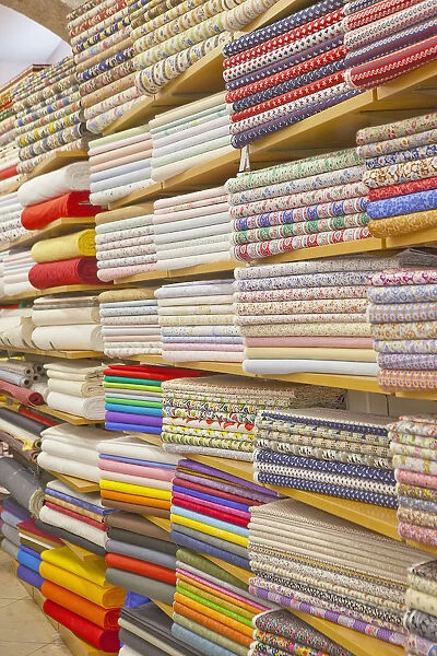 Portugal, Estremadura, Lisbon, Baixa district, Display of various fabrics for sale