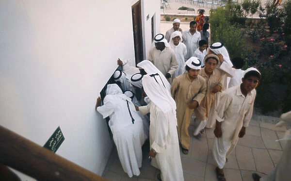 Qatar, Doha, Crowds of men at Doha Museum