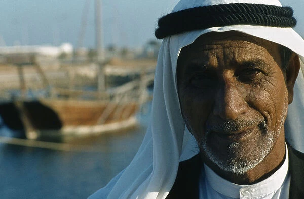 Qatar, Doha, Portrait of a man in the harbour wearing traditional head covering with a