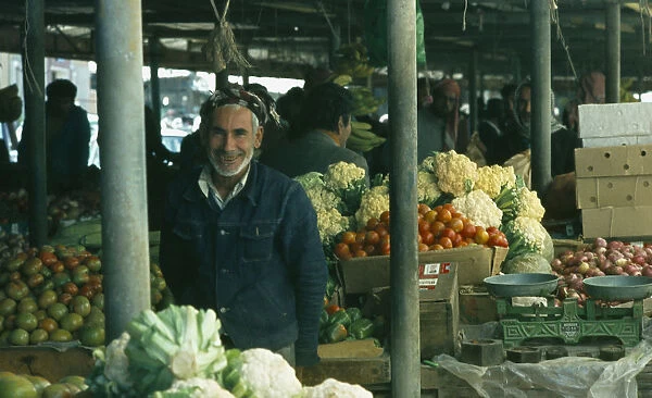Qatar, Doha, The Souk or market with man selling vegetables at his stall