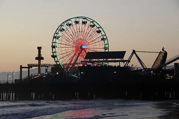 Santa Monica pier Silhouetted at dusk. Ferris wheel funfair