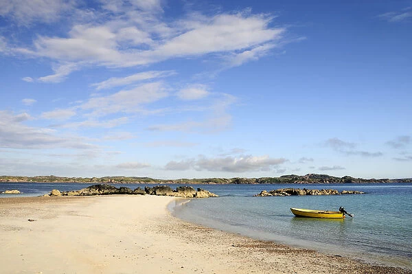 SCOTLAND, Argyll, Isle Of Mull, Sandy beach & clear waters with yellow boat anchored near