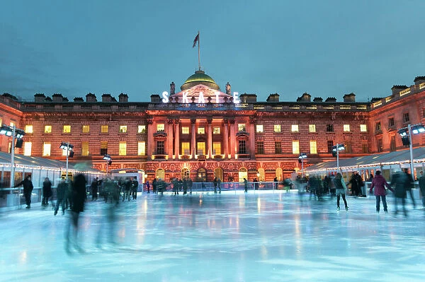 Skaters, early evening on the seasonally assembled ice rink at Somerset House, London