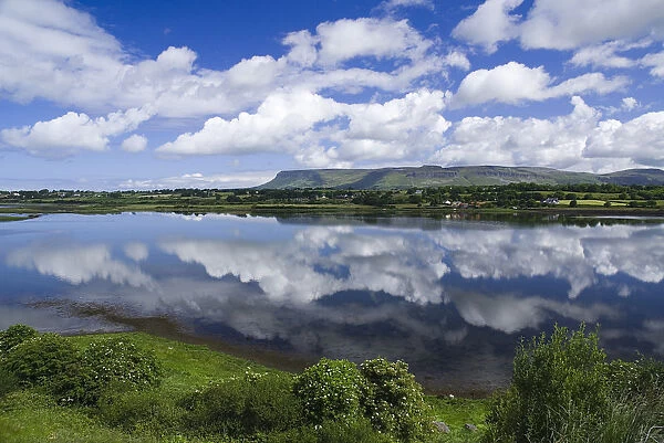 Sligo Bay and Ben Bulben from outskirts of the town. Blue sky and white cloudscape reflected in water