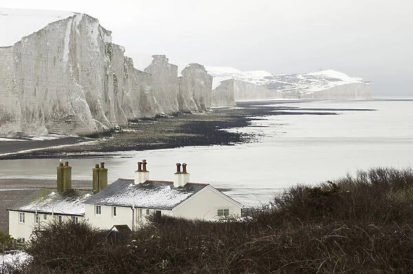 The snow covered chalk cliffs of the Seven Sisters viewed from across from the coastguard