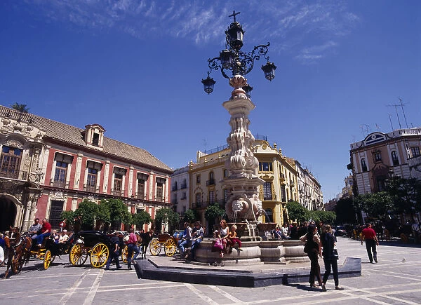 Spain, Andalucia, Seville, Santa Cruz District Plaza Virgen de los Reyes Palacio Arzobispal on the left fountain horse carriages people