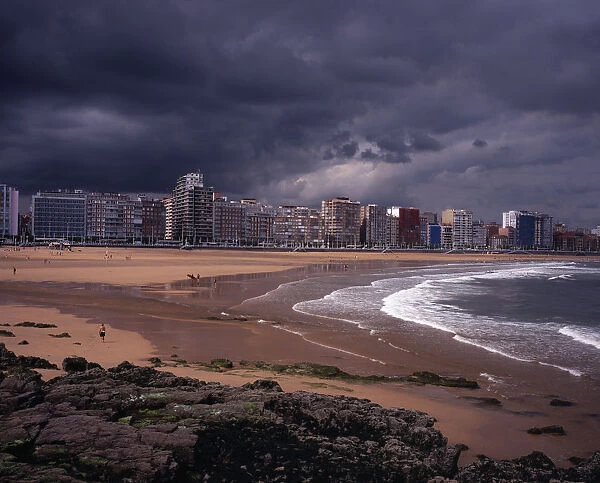 SPAIN, Asturias, Gijon High rise city buildings overlooking beach with people in water