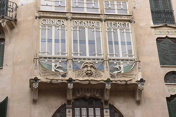 Spain, Balearic Islands, Majorca, Palma, Art Nouveau grotesque face on Dental Clinic in the Old City