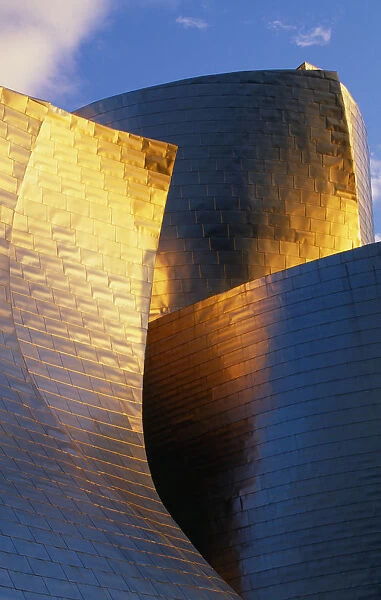Spain, Basque Province, Bilbao, Exterior of the Guggenheim Museum in warm light, designed by Frank Gehry