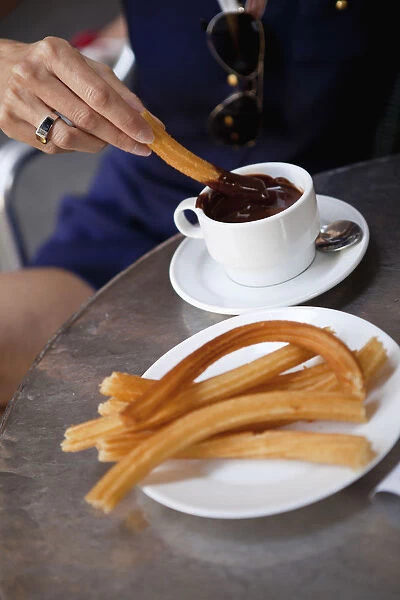 Spain, Madrid, Eating churros with hot chocolate