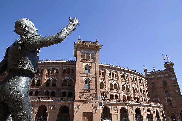 Spain, Madrid, Statue of a matador with the Plaza de Toros de las Ventas in the
