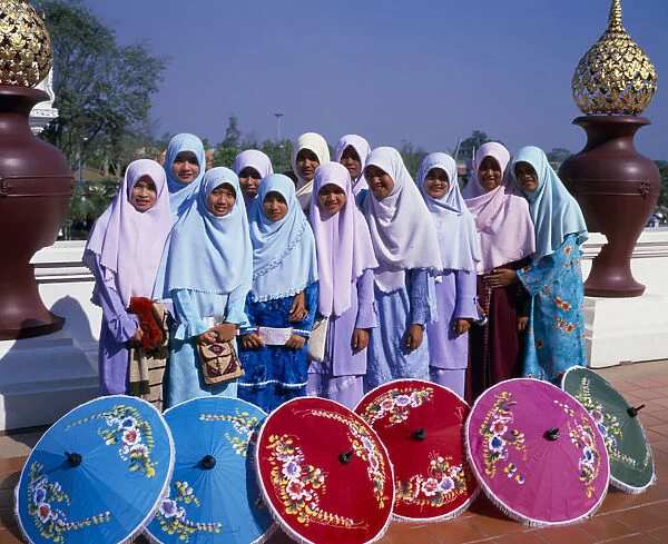 THAILAND, North, Chiang Mai Group of young Muslim Thai women standing behind blue, red