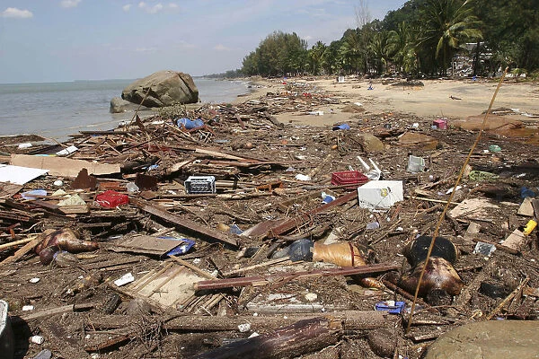 Tsunami. Bodies lay mixed with all the debris on the beach caused by the dissaster. Now the devestation can be seen in the remote areas. This was about 60kms north of Phuket at Khaolak Beach with the destruction of Khaolak Resort in the background