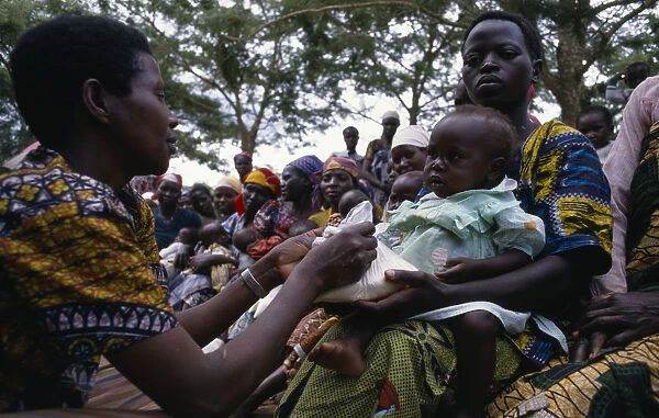 UGANDA Health worker giving nutritional advice to mothers with vulnerable babies